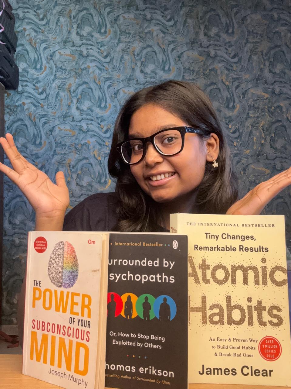 Vridhi Kumar with The Power of Your Subconscious Mind, Surrounded by Psychopaths, and Atomic Habits