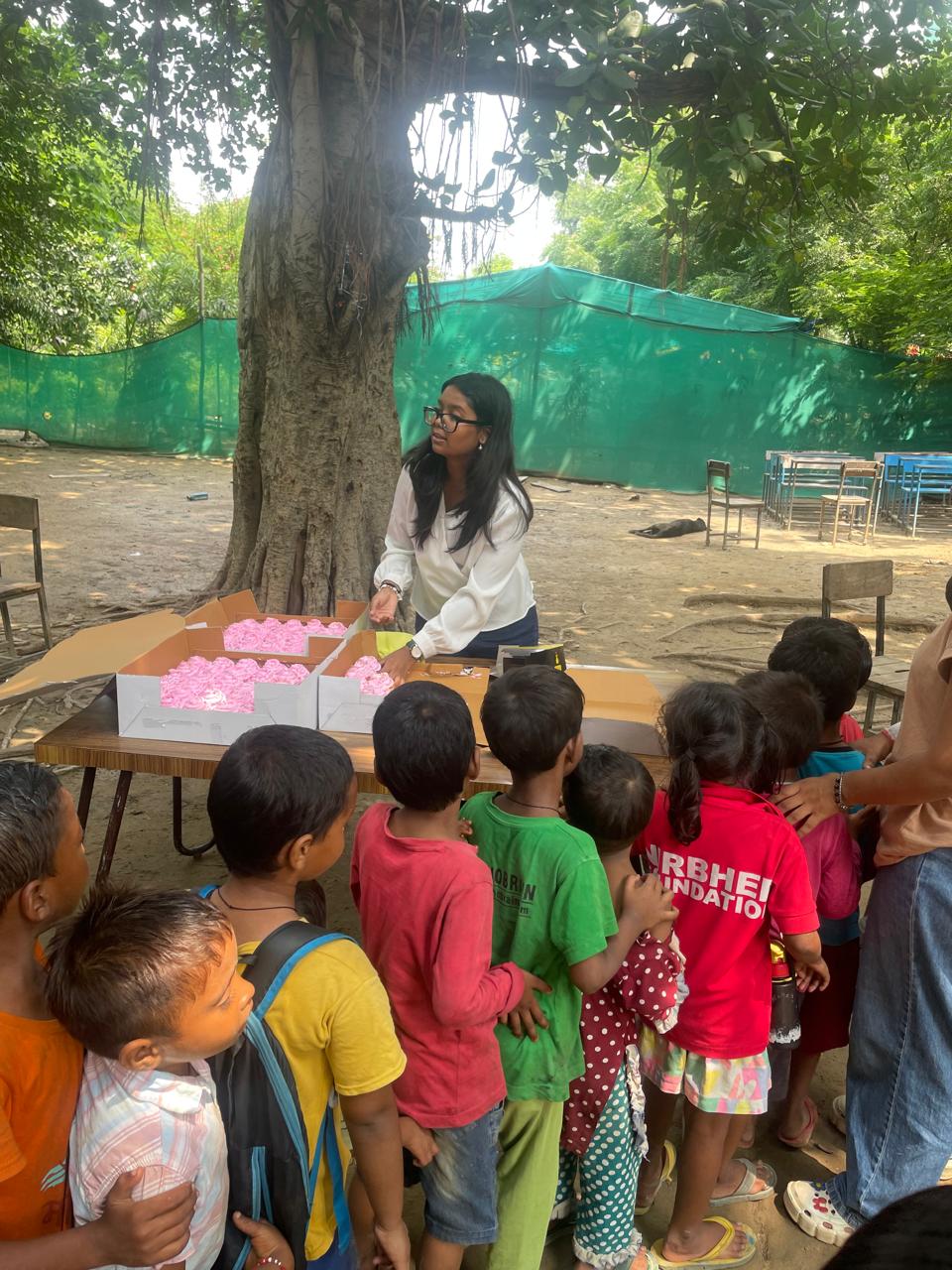 Distributing cupcakes to children at Nirbhed Foundation