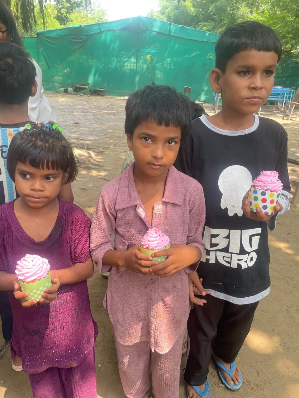 Children holding cupcakes at Nirbhed Foundation